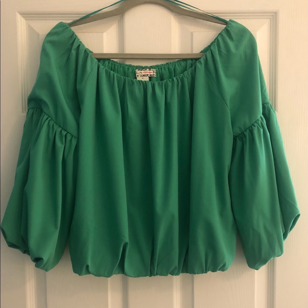 Shoulder less green top with mid length sleeves.